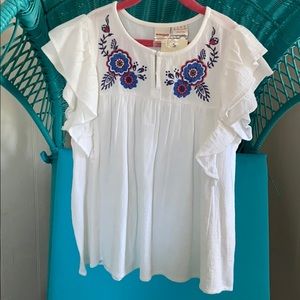 White ruffled elegant shirt with floral accents